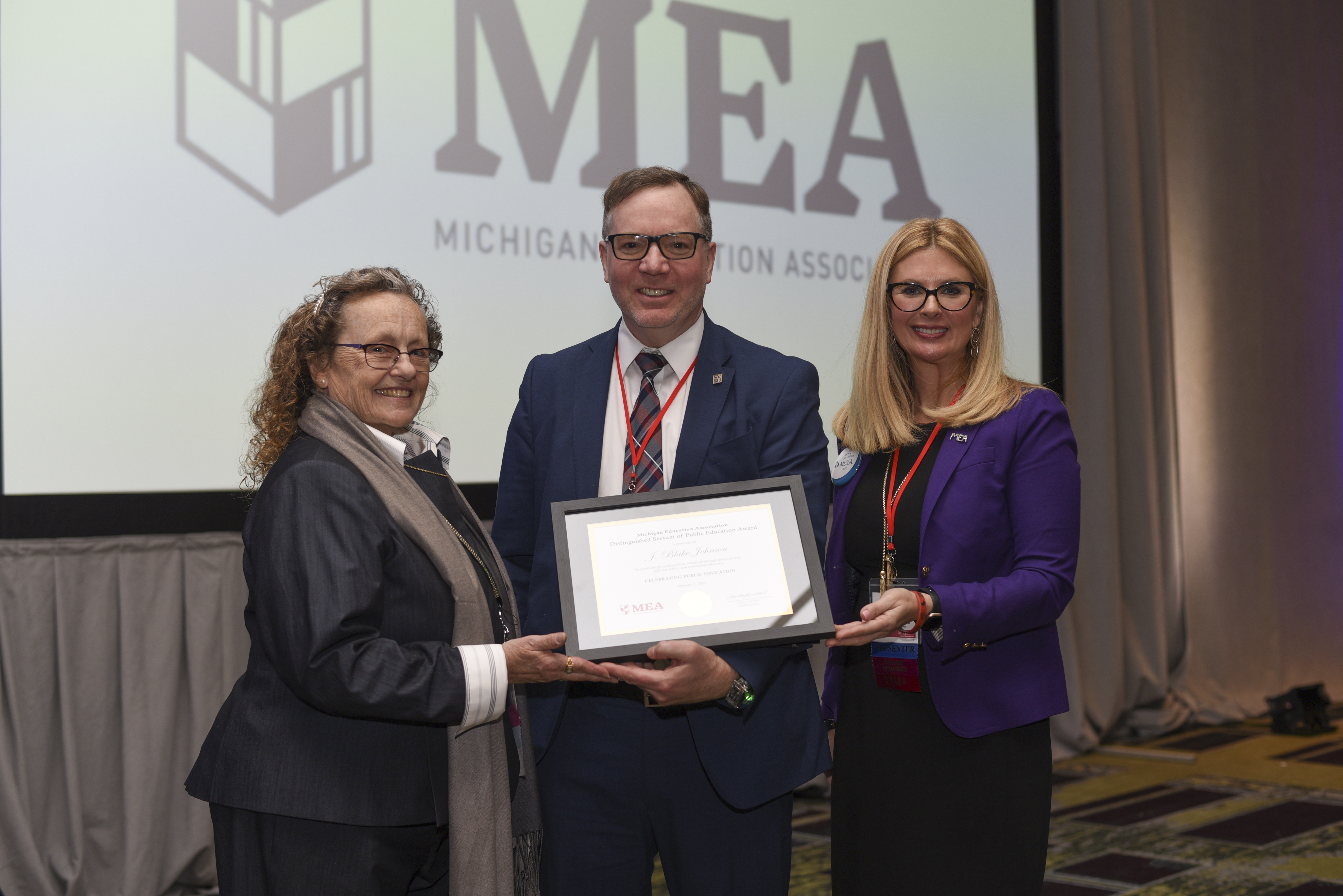 Man flanked by two women